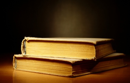 old book on a dark background and light beamの写真素材