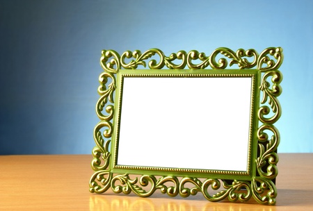 The old green border with a pattern on a blue gradient background.の写真素材