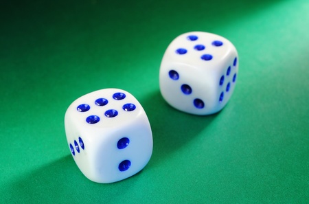 White dice with a blue dot illumination beam of lightの写真素材