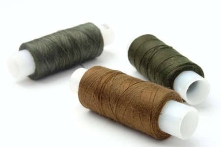 Coils with threads of different color on a white background