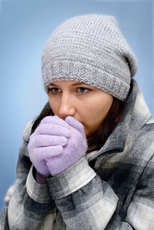 The young girl warms hands from a frostの写真素材