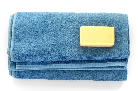 blue bathing towel and bar of soap on a white backgroundの写真素材