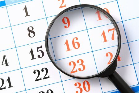 magnifier is a black page of the calendarの写真素材