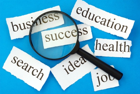 magnifying glass and a piece of paper with the words "succest" on a blue backgroundの写真素材