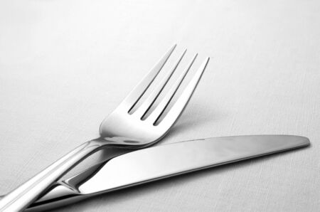 fork and knife on a napkin on the tableの写真素材