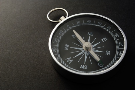 black metal compass on a black backgroundの写真素材