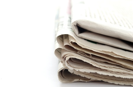 stack of newspapers on a white background