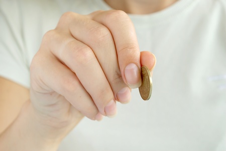 one coin in a hand of the girlの写真素材