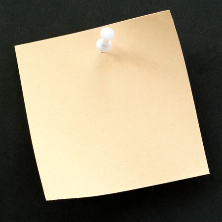 sheet of paper for notes and pushpin on a black background
