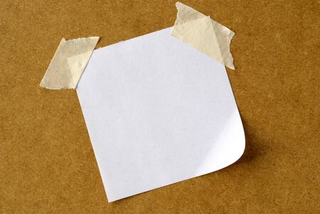 sheet of paper for notes and stuck tape on the boardの写真素材