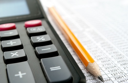 calculator and stationery items on the tableの写真素材