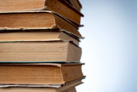 stack of old books on a blue background