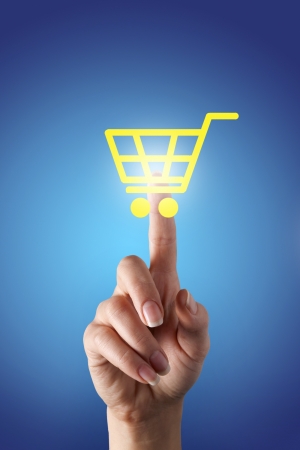 she presses the button in the form of a virtual shopping cartの写真素材