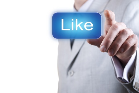 man in a suit presses the virtual button like