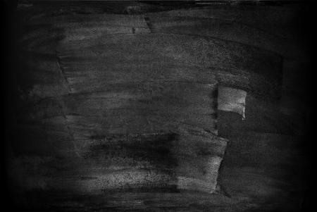 chalkboard with smeared spots from a text written in chalkの写真素材