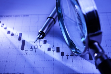 Business graph with fountain pen and magnifying glass conceptual of analysis, research and strategy planningの写真素材