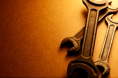 Set of three different sized spanners in a sepia toned image with a graduated background and copyspaceの写真素材