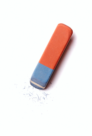 Blue and red eraser or rubber with rubber residue on white conceptual of school, art and office suppliesの写真素材