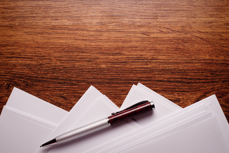 Conceptual Ballpoint Pen and Blank Sheets, Above Wooden Table with Copy Space on Top.