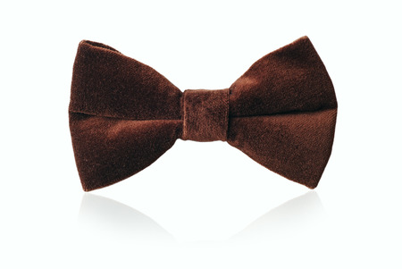 Mans brown velvet bow tie for evening wear or a gentlemans attire, standing upright on whiteの写真素材