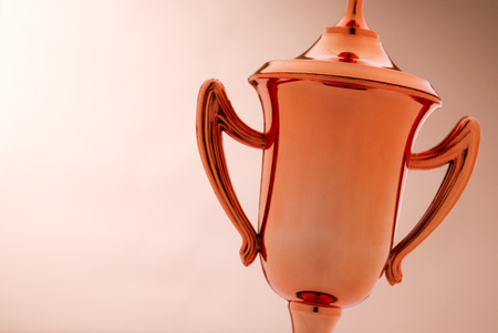Close up of the cup of a bronze trophy with copyspace to be awarded as a prize to the third placed winner in a competitionの写真素材