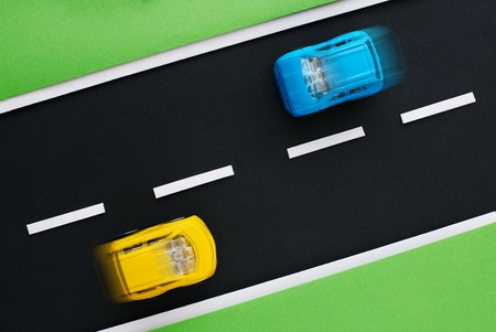 Close-up of children's highway with yellow and blue cars. View from above.の写真素材