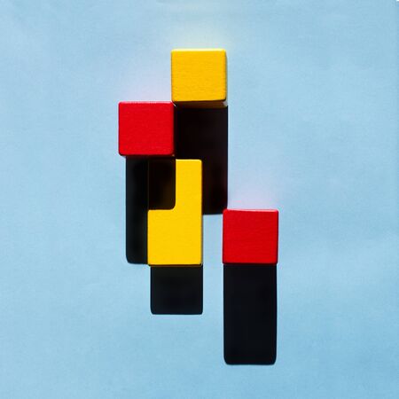 Wooden blocks and dark shadows, creating an abstract pattern