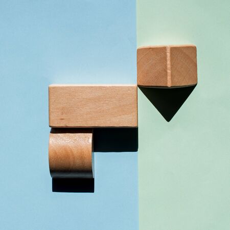 Wooden blocks and dark shadows, creating an abstract pattern