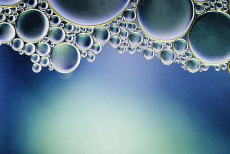 oil drops on a water surface abstract background blueの写真素材