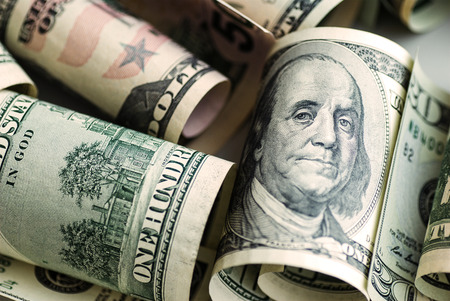 Paper denominations of dollars on the table