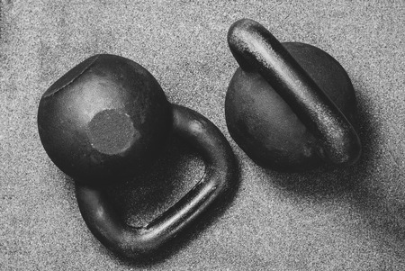 two heavy kettlebell black on gray backgroundの写真素材