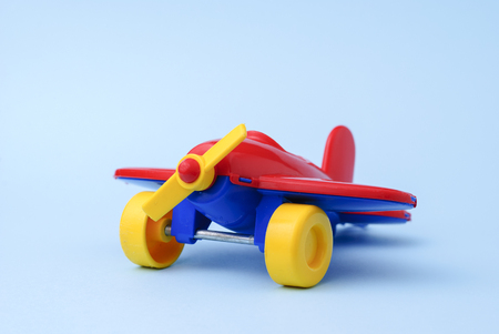 Toy childrens red plane on a blue backgroundの写真素材
