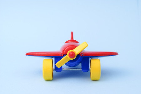 Toy childrens red plane on a blue backgroundの写真素材