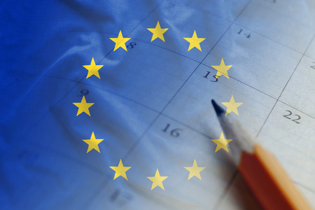 European Union flag and calendar with pencil for making reminders on important dates of political events. Full frame background concept for EU politics themeの写真素材