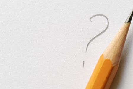 Pencil next to drawn question mark on white paper with copy space.の写真素材