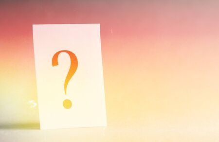 Paper card with a question mark on a gray background, concept.の写真素材