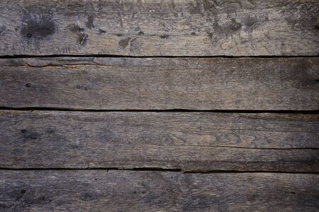 Dark grey old wooden boards background, arranged horizontally. Unpainted wall or fence naturally...