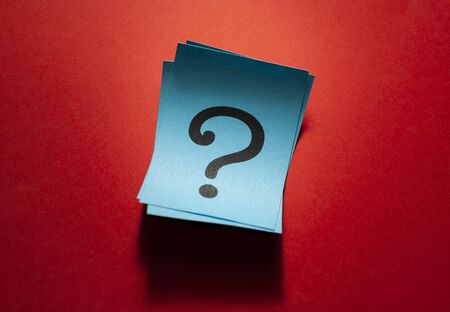 Curled blue paper cards with question marks