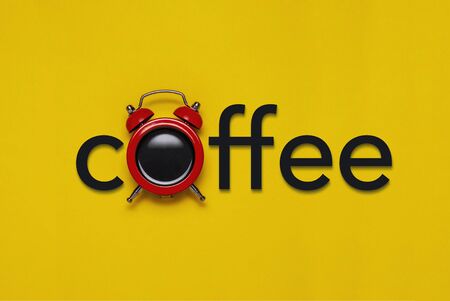 Coffee concept with alarm clock and text over a colourful yellow background conceptual of a countdown to a coffee breakの写真素材