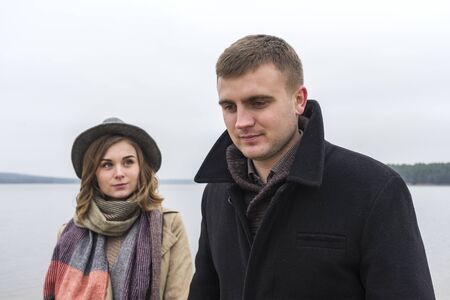 Attractive young woman watching her boyfriend on a cold misty winter dayの写真素材