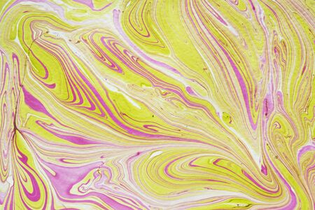 Delicate abstract marbleized pattern with fine swirling lines of pink on yellow and white in a full frame view for wallpaper or printの写真素材