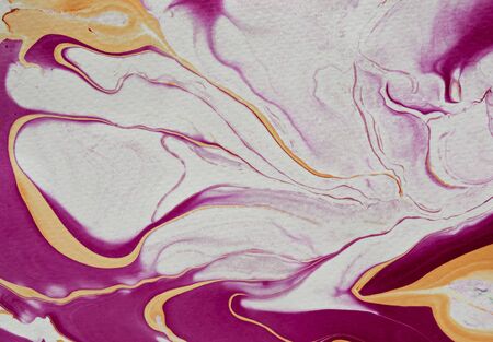 DIY fluid marbling abstract background with free flowing magenta, white and golden yellow in full frameの写真素材