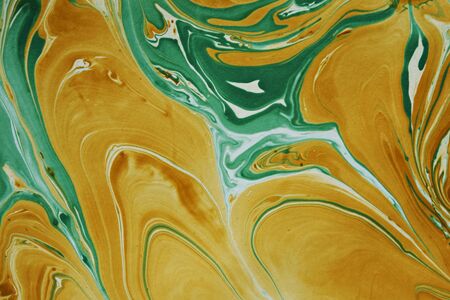DIY marble background texture abstract pattern wallpaper design in green and gold with swirling...