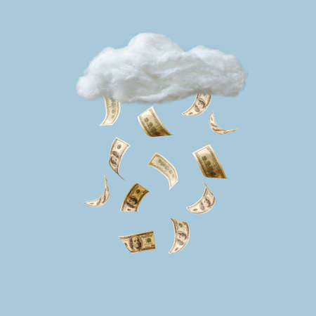 Money dollars as a symbol of wealth falling from the cloud. Bills fly in the air. Savings, savings, wealth and security concept. Minimal creative idea.の写真素材