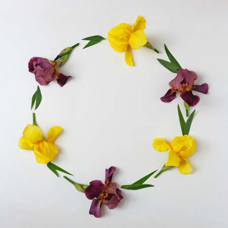 Invitation with a border and a wreath of yellow and purple irises. Modern decorative banner idea.の写真素材