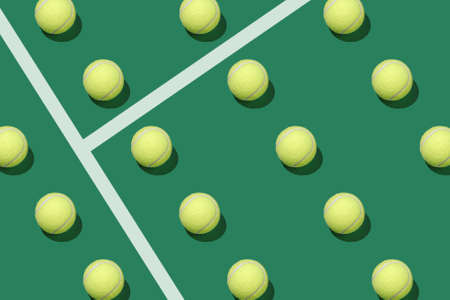 Pattern of pastel tennis balls on a tennis court. Minimal creative sports concept.の写真素材