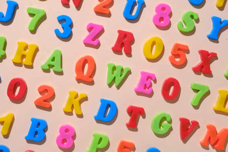 Alphabet letters and numbers as a concept for back to cheekbones. Minimal pastel education idea.