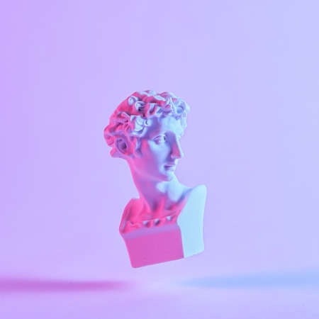 Monotone purple still life of a floating antique style Roman or Grecian bust with drop shadow in...