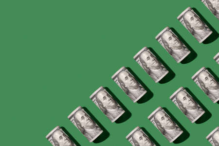 Diagonal pattern copy space top view dollar banknote on green background modern concept of finance...