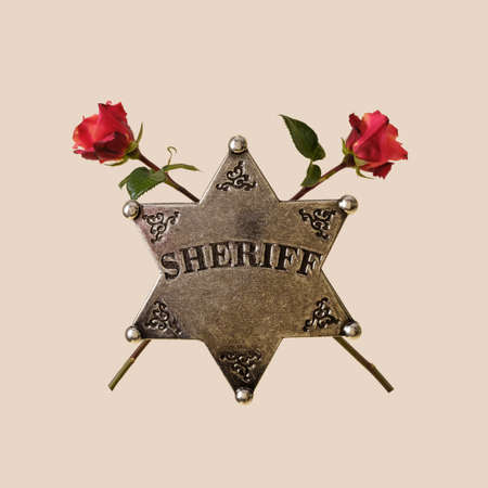 Sheriff star and roses concept of wild west law enforcement police detective and love and holiday.の写真素材